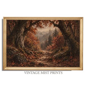 Peut inclure: Une peinture de paysage encadrée représentant un sentier forestier automnal bordé de grands arbres texturés aux feuillages brun et orange. La scène montre un chemin rocailleux jonché de feuilles menant vers des montagnes brumeuses. Texte VINTAGE MIST PRINTS.