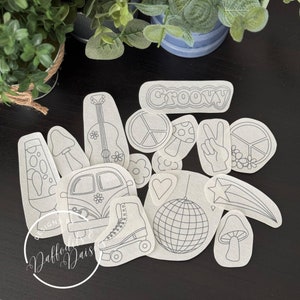 May include: A set of 14 black and white iron-on patches with a groovy 70s theme. The patches include a peace sign, a mushroom, a lava lamp, a guitar, a van, a disco ball, a roller skate, a star, a peace sign hand, and the word "Groovy".