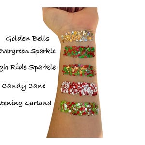 May include: Five different colors of glitter, labeled "Golden Bells", "Evergreen Sparkle", "Sleigh Ride Sparkle", "Candy Cane", and "Glistening Garland".