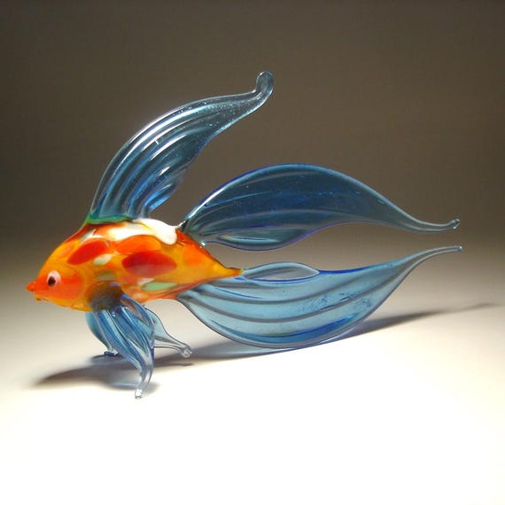 A hand-blown glass betta fish with 455 favorites — the vivid colors and flame-worked fins capture the actual iridescent drama of a live betta in solid glass.