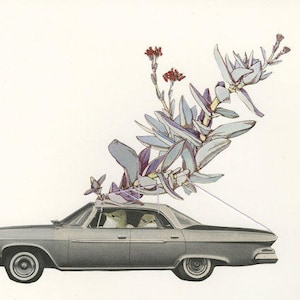 May include: A vintage silver car with a bouquet of purple and blue flowers on top. The car is driving down a road with a white background.