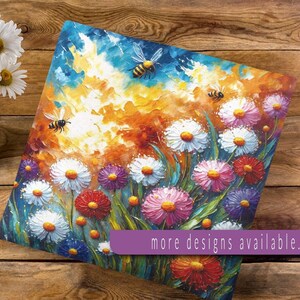 May include: Square canvas art featuring a vibrant floral painting with white, pink, and red daisies, and buzzing bees. The artwork has a textured, impressionistic style with a warm color palette of orange, yellow, and blue. Text: more designs available...