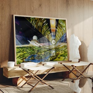 May include: A framed artwork depicting a futuristic landscape with a figure in a white suit. The artwork hangs above a wooden bench with two folding stools with white canvas seats. A white sculpture and a paper lantern are also visible.