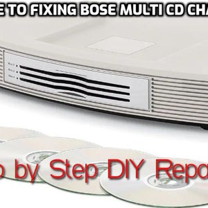 May include: A white Bose multi-CD changer with a silver front panel and a CD slot. The changer is sitting on a white surface with four blank CDs in front of it. The text "Step by Step DIY Repair KIT" is written in red below the CDs.