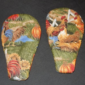 May include: Two green, brown, and red fabric pot holders with a rooster and pumpkin design.