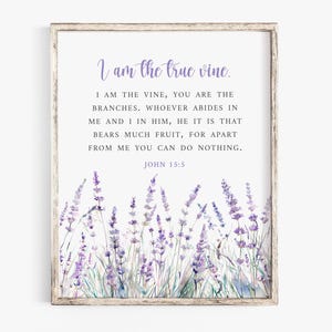 May include: Framed print featuring the text "I am the true vine." The text is in a soft purple script, with the full verse below. Watercolor lavender flowers are at the bottom. The frame is a light, neutral color.