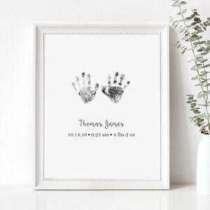 May include: Black and white handprint art print with the name "Thomas James" and the date "10.14.16 - 6:23 am - 4 lbs 2 oz" printed below.