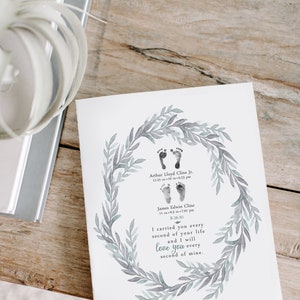 May include: A watercolor print with a wreath of leaves and two sets of baby footprints. The print includes the names Arthur Lloyd Cline Jr., 12.25 oz 10 in 6:53 pm, James Edwin Cline, 11 oz 9.5 in 7:01 pm, 8.26.91, and the text "I carried you every second of your life and I will love you every second of mine."