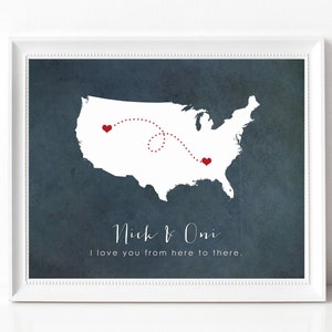 May include: A blue and white print with a white outline of the United States map. A red dotted line connects two red hearts on the map. The text "Nick & Oni" and "I love you from here to there." is printed below the map.