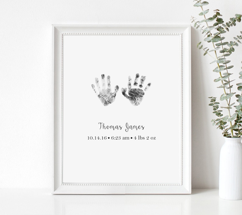 May include: Black and white handprint art print with the name "Thomas James" and the date "10.14.16 - 6:23 am - 4 lbs 2 oz" printed below.