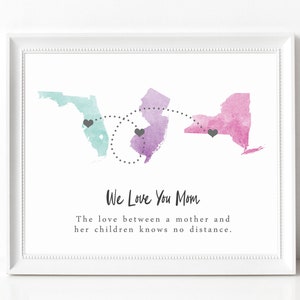 May include: A watercolor print with the states of Florida, New Jersey, and New York. The states are connected by a dotted line with hearts at each location. The text "We Love You Mom" is below the states, and the text "The love between a mother and her children knows no distance." is below that.