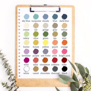 May include: A color chart with 24 different paint colors, each with a name written below it. The colors include sky blue, turquoise, cloudy, blue, dark blue, cream, oat, greige, gray, wheat, celery, olive, green, tan, mist, butter, honey, yellow, peach, orange, lavender, purple, ash violet, pink, bright pink, wine, salsa, cinnamon, crimson, ruby, white, camel, chocolate, charcoal, and black.