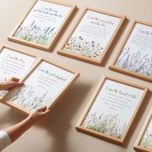 May include: A set of framed art prints with inspirational quotes and floral illustrations. The wooden frames surround white backgrounds with text in various colours. The artwork features lavender, wildflowers, and wheat.