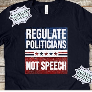 May include: A navy blue t-shirt featuring a distressed red, white and blue graphic that reads "Regulate Politicians Not Speech". The graphic has a vintage look and includes stars and stripes. The shirt is available in multiple colours and unisex sizing.
