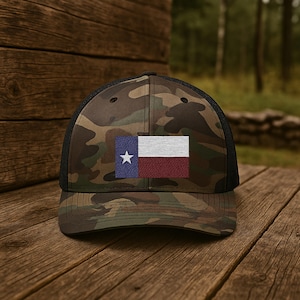 May include: A camouflage baseball cap with a black mesh back and a Texas flag embroidered on the front.