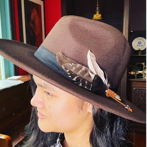 Cowboy hat with unique feather pin