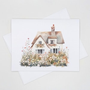 May include: A watercolor painting of a white cottage with a brown roof and a chimney. The cottage is surrounded by a lush garden with flowers in shades of pink, yellow, and white.