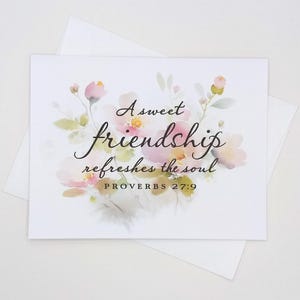 May include: A white greeting card with a floral design and the text "A sweet friendship refreshes the soul" in elegant script. The card features watercolor-style pink and yellow flowers and the Bible verse Proverbs 27:9.