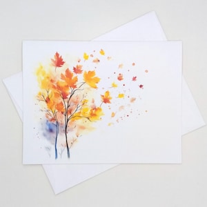 May include: A rectangular greeting card featuring a watercolor illustration of two trees with autumn foliage in shades of red, orange, and yellow. The leaves appear to be blowing toward the right side of the card, with scattered paint splatters.