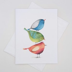 May include: Three watercolor painted birds stacked on top of each other. The top bird is blue, the middle bird is green, and the bottom bird is red.
