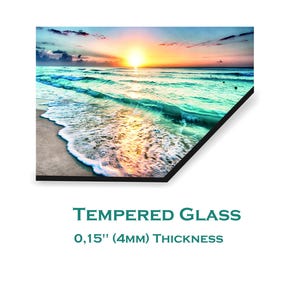 May include: A colourful sunset over a turquoise ocean with white foamy waves crashing on a sandy beach. The image is printed on tempered glass with a 0.15" (4mm) thickness.
