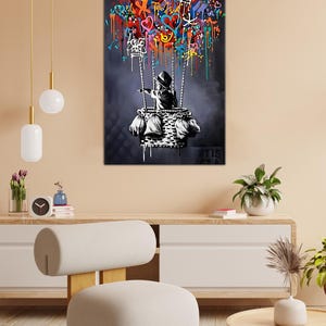 May include: A black and white illustration of a child in a hooded jacket holding onto a hot air balloon made of colourful graffiti. The balloon is filled with hearts, stars, and other abstract shapes.