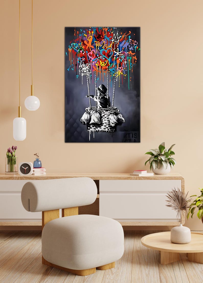 May include: A black and white illustration of a child in a hooded jacket holding onto a hot air balloon made of colourful graffiti. The balloon is filled with hearts, stars, and other abstract shapes.