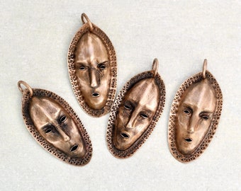 1 Vintage African Mask Pendant - repousse copper face with stamped details 2" long - unworn old stock