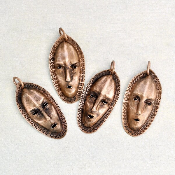 1 Vintage African Mask Pendant - repousse copper face with stamped details 2" long - unworn old stock