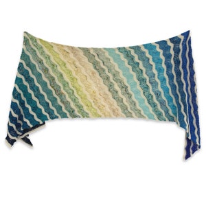 May include: A blue, green, and cream knitted shawl with a wavy pattern.