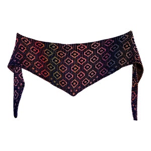 May include: A black and rainbow coloured triangular shawl with a geometric pattern. The shawl has two long ties.