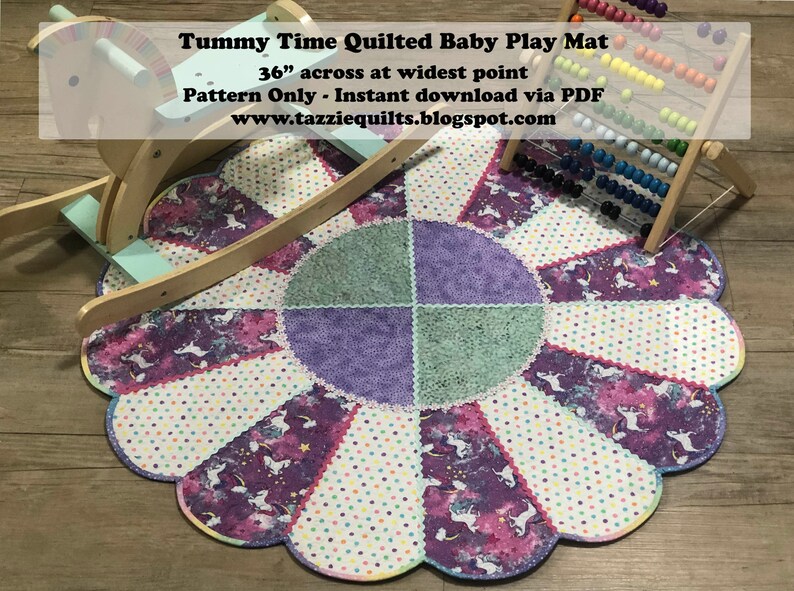 May include: A quilted baby play mat with a scalloped edge and a center circle design. The mat is made of purple, green, and white fabric with a unicorn print. The mat is 36 inches across at its widest point. Tummy Time Quilted Baby Play Mat 36" across at widest point Pattern Only - Instant download via PDF www.tazziequilts.blogspot.com