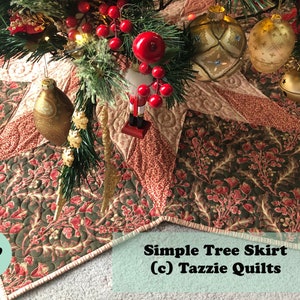 May include: A quilted Christmas tree skirt in shades of green, red, and cream with a starburst design. The skirt is 46 inches in diameter and has a simple tree skirt (c) Tazzie Quilts label.