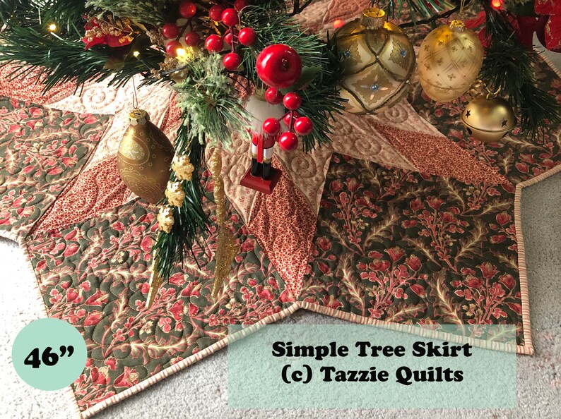 May include: A quilted Christmas tree skirt in shades of green, red, and cream with a starburst design. The skirt is 46 inches in diameter and has a simple tree skirt (c) Tazzie Quilts label.