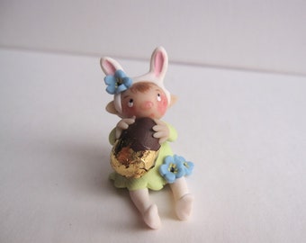 Little bunny figurine with  faux easter chocolate