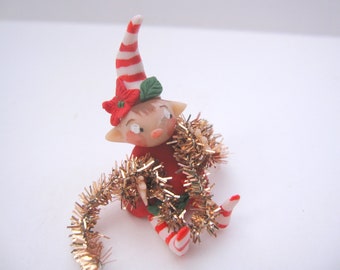 Figurine of miniature christmas pixie elf ornament