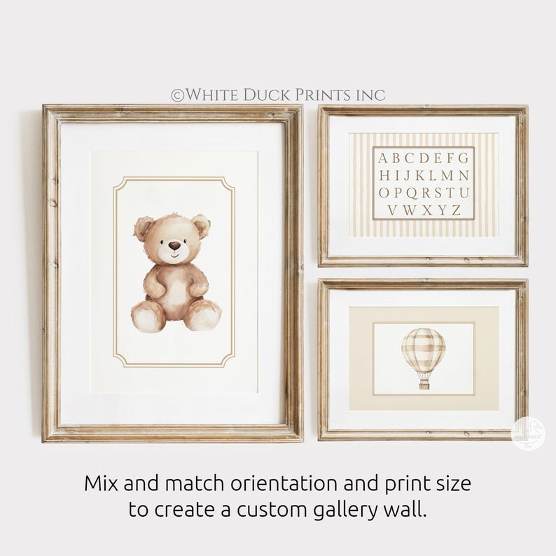 May include: Three framed prints with a nursery theme. One features a watercolor teddy bear, another an alphabet chart, and the third a hot air balloon. The frames are light brown. Text on the image reads: Mix and match orientation and print size to create a custom gallery wall.