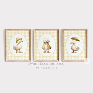 May include: Three framed prints featuring watercolor illustrations of ducks. Each duck is depicted in a different outfit: a hat, a coat, and an umbrella. The background is a yellow and white gingham pattern, with the text "WHITE DUCK PRINTS INC Printable Art".
