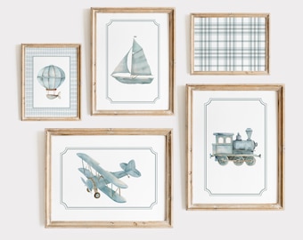 May include: Set of five framed watercolor prints featuring various modes of transportation. The prints include a hot air balloon, a sailboat, a biplane, a train, and a plaid pattern.