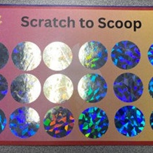 May include: Scratch-off game card with the text "Scratch to Scoop" and 18 circular scratch-off areas. The card has a pink and orange background with an ice cream cone and a cupcake on either side of the text.
