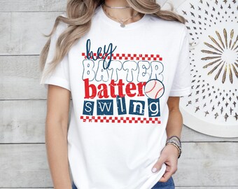 May include: White t-shirt with the text "Hey Batter Batter Swing" in blue and red block letters. A baseball graphic is included. The shirt has a crew neck and short sleeves.