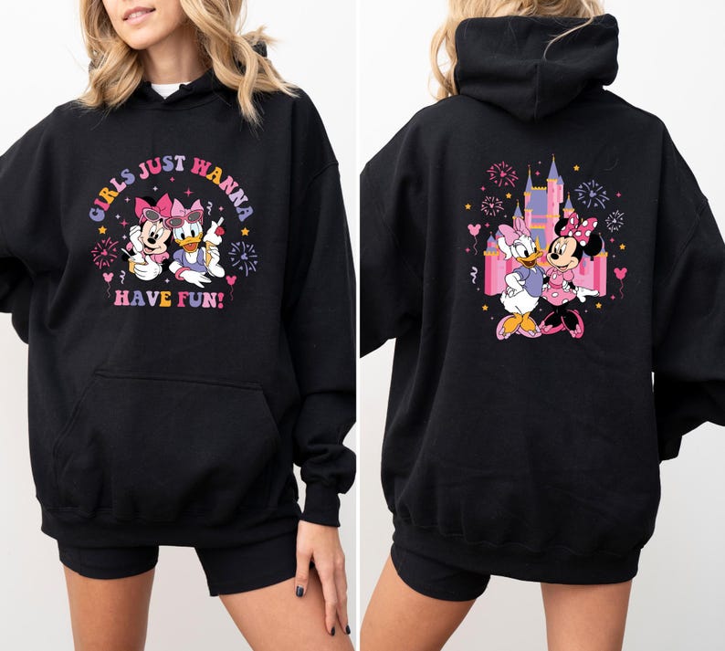 May include: Black hoodie with a graphic print of Minnie Mouse and Daisy Duck in front of a pink castle. The text "Girls Just Wanna Have Fun!" is printed on the front of the hoodie.