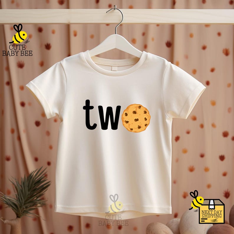 a white t - shirt with a cookie and the word tw on it