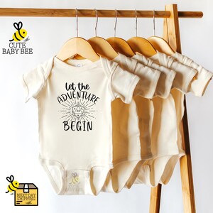 a baby's bodysuit hanging on a clothes line