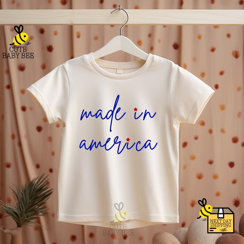 a t - shirt that says made in america hanging on a clothes line