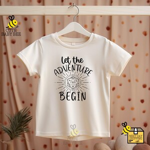 a t - shirt that says let the adventure begin
