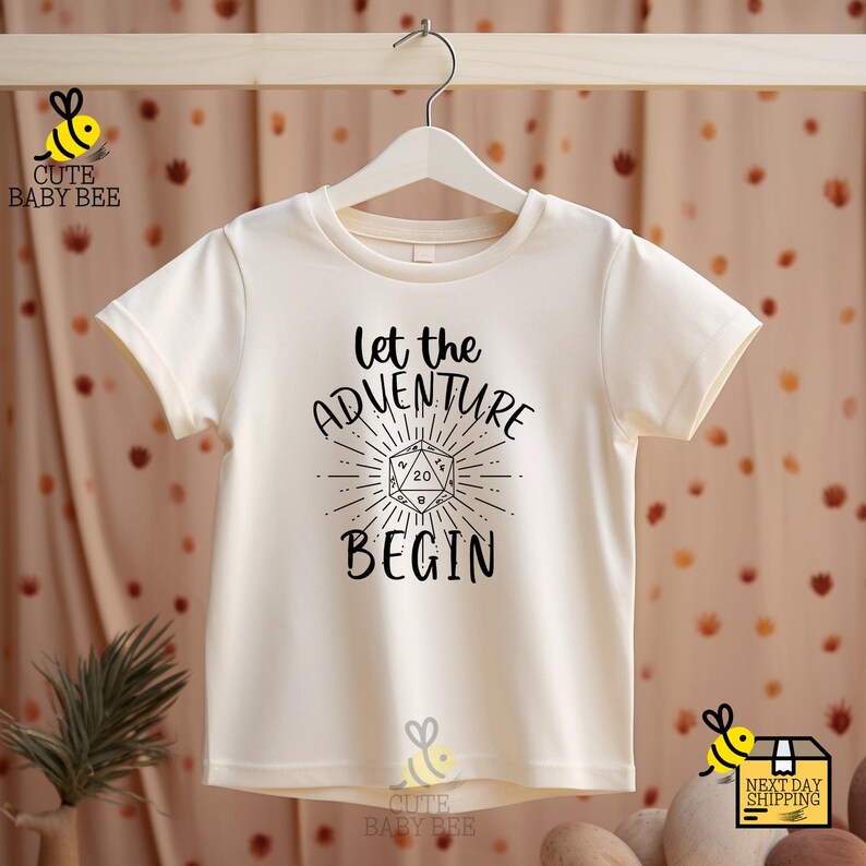 a t - shirt that says let the adventure begin