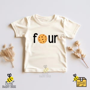 a baby t - shirt with a cookie and the words four printed on it