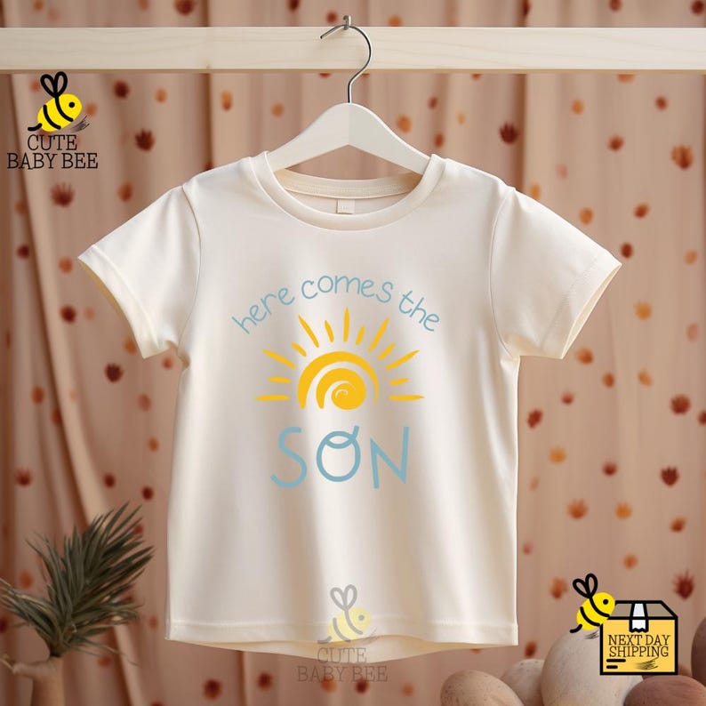 a t - shirt that says, here comes the son