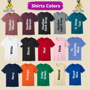 a collection of t-shirts in various colors, including maroon, gray, teal, light gray, dark gray, pink, and blue.